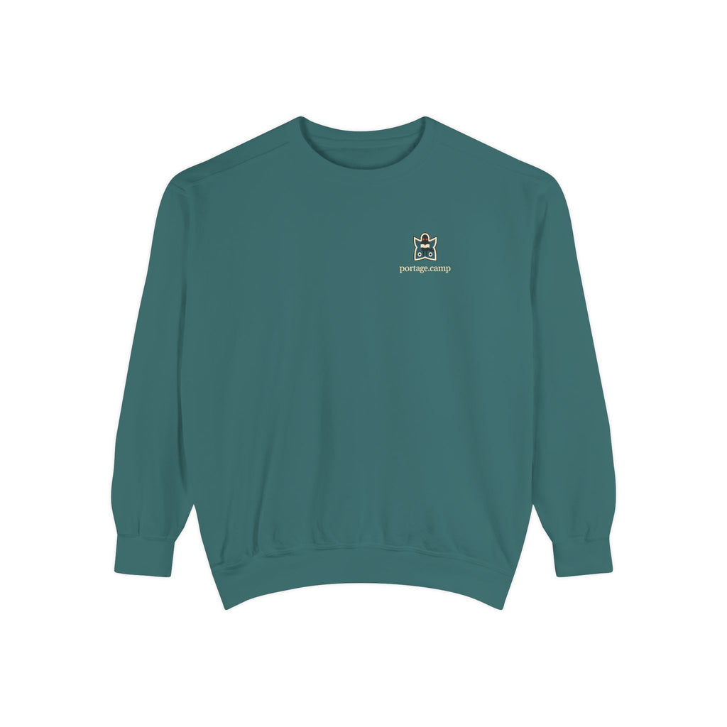 Night Library Garment-Dyed Crewneck in Blue Spruce, front view with the Night Library logo and portage.camp on the chest. Digital product mockup.