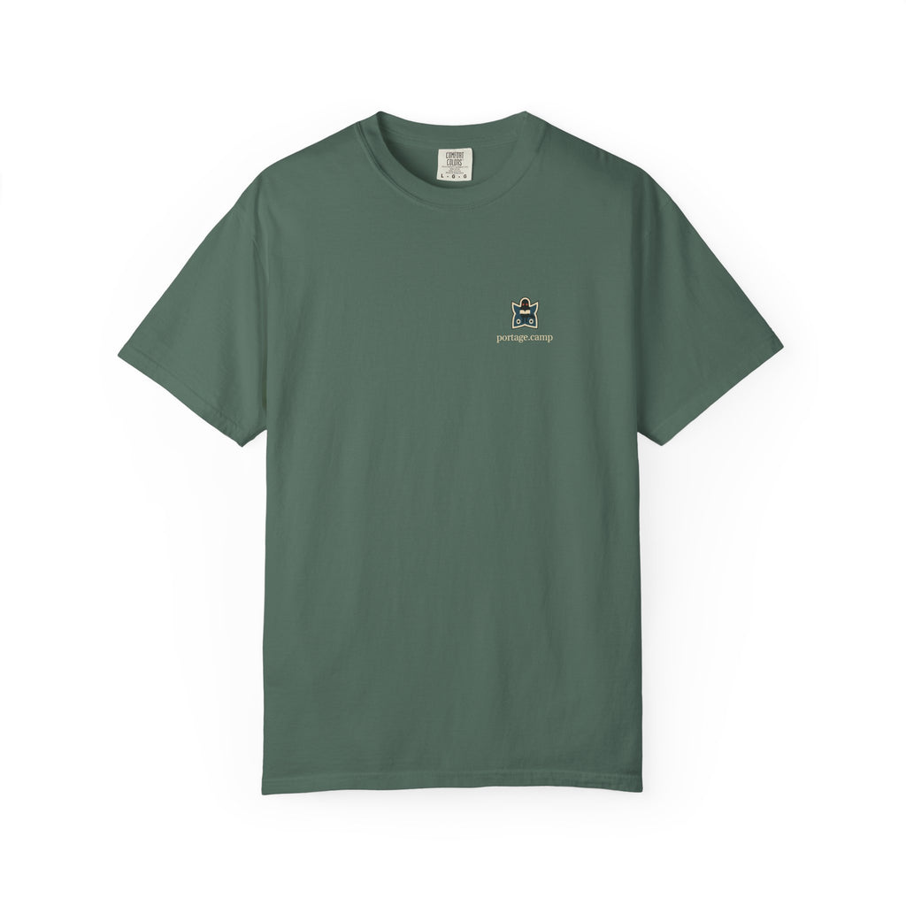Night Library Garment-Dyed Tee in Blue Spruce, front view with the Night Library logo and portage.camp on the chest. Digital product mockup.