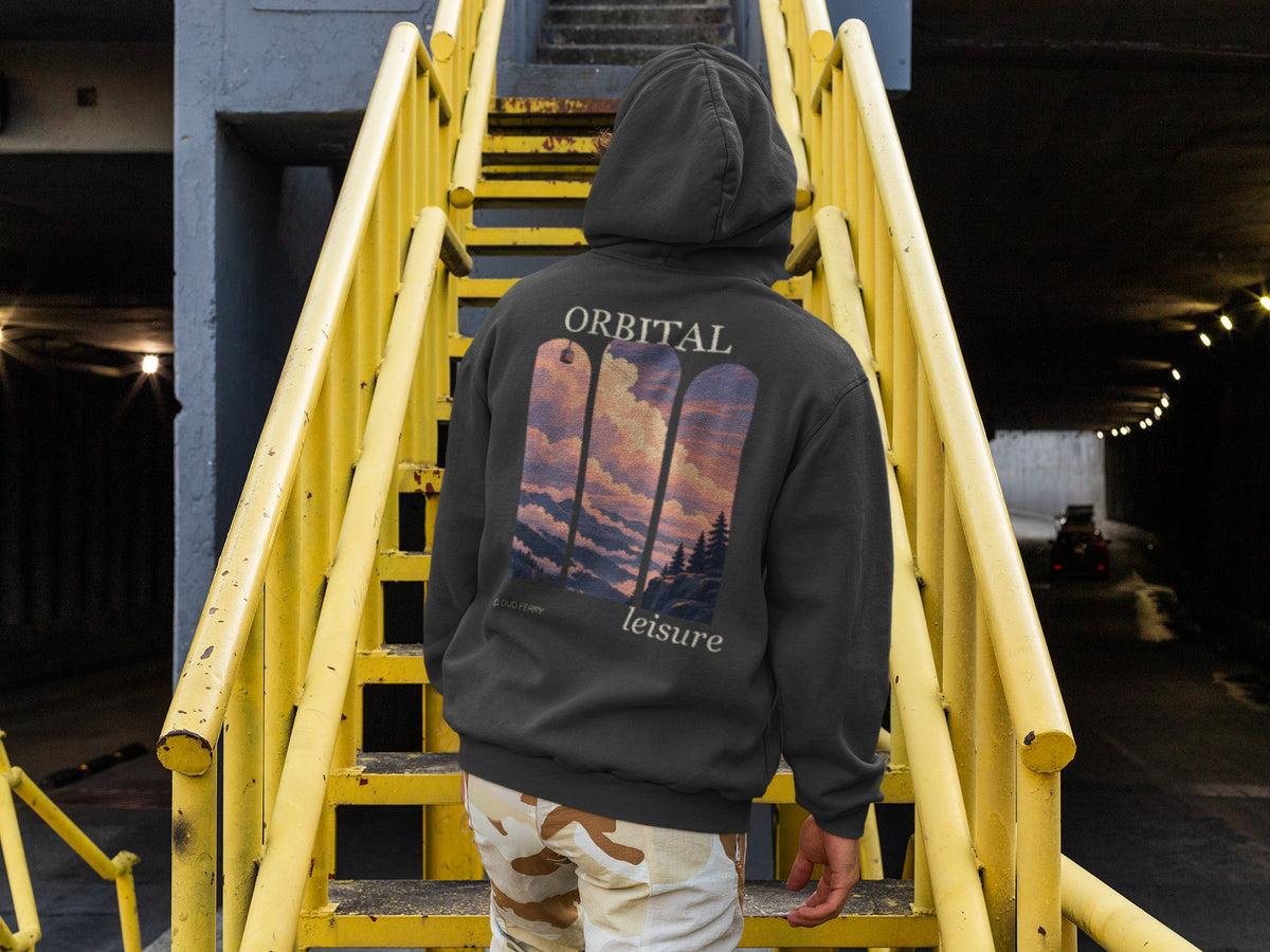 Cloud Ferry Zip Hoodie in Black, worn by a man seen from behind climbing a yellow metal staircase, showing the large print on the back. Digital product mockup.