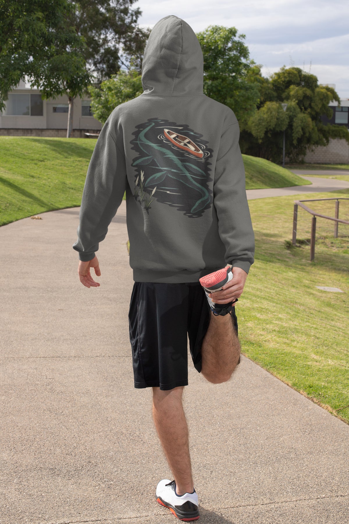 Seen Briefly Zip Hoodie in Dark Heather, worn by a man seen from behind on a sunny path, ready for a run, showing the large print on the back. Digital product mockup.