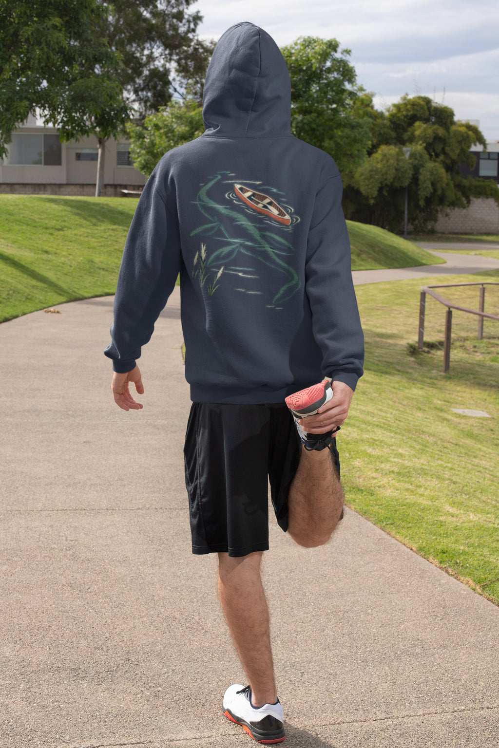 Seen Briefly Zip Hoodie in Navy, worn by a man seen from behind on a sunny path, ready for a run, showing the large print on the back. Digital product mockup.