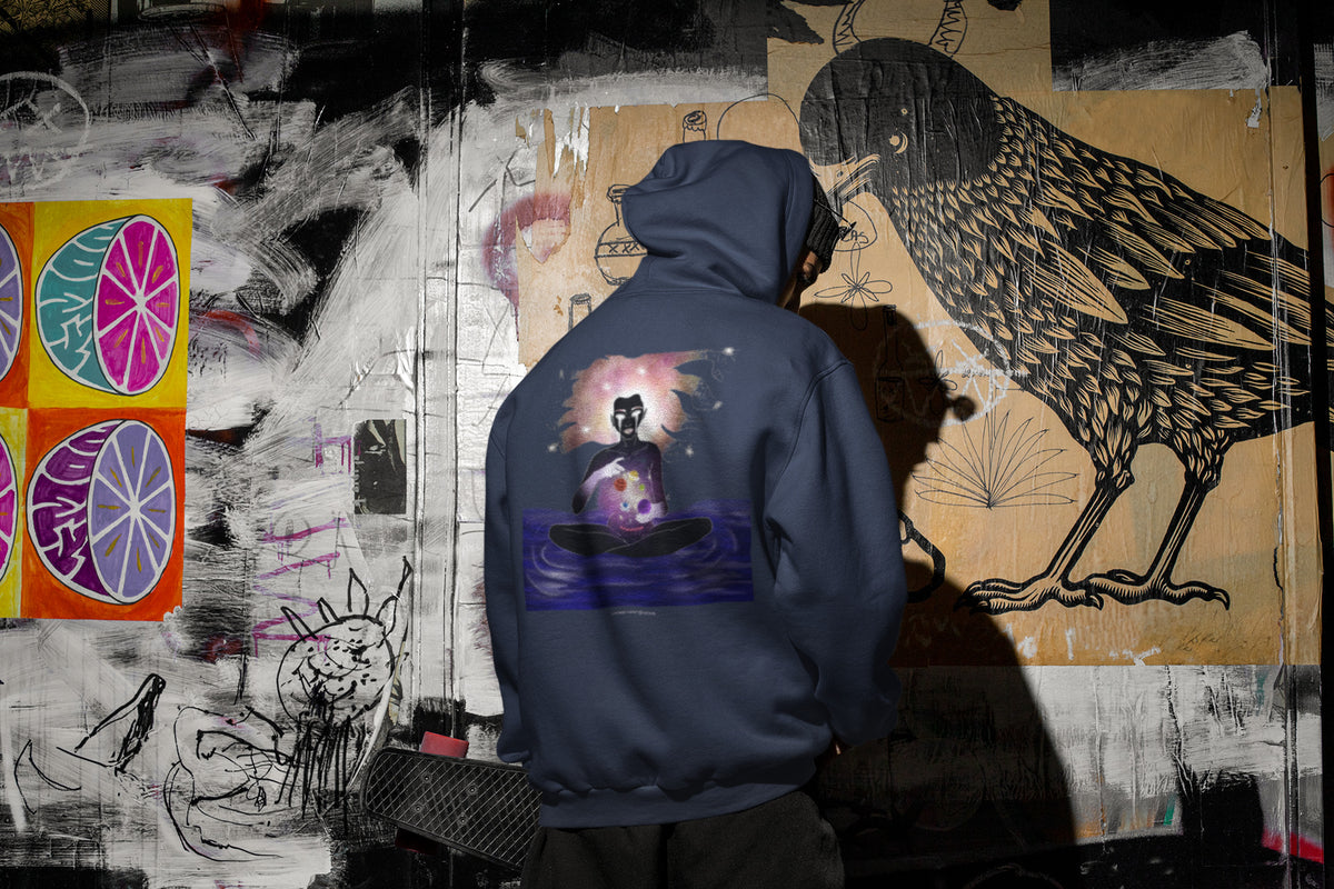 Orbit Keeper Zip Hoodie in Navy, worn by a man seen from behind in a dark alley, showing the large print on the back. Digital product mockup.