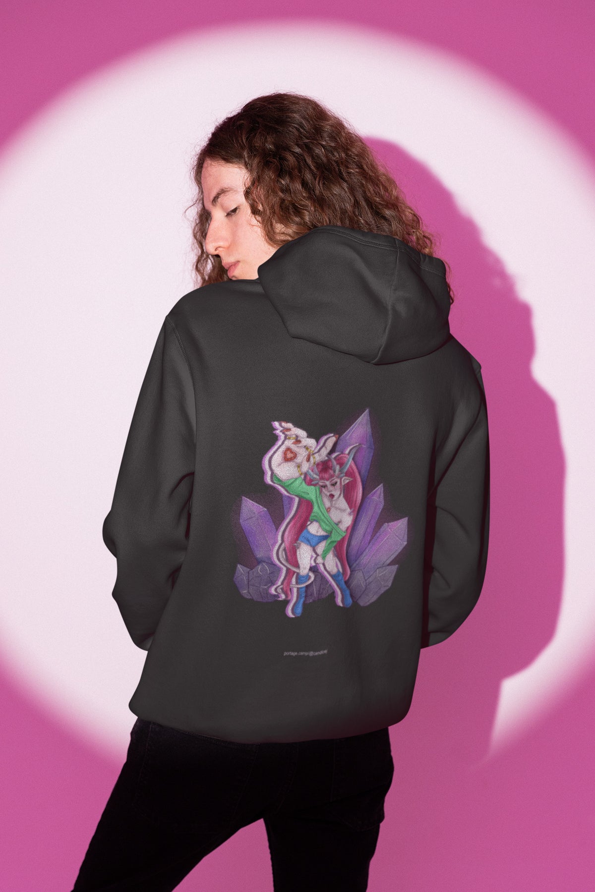 Heart Thief Zip Hoodie in Black, worn by a man seen from behind in a studio under pink light, showing the large print on the back. Digital product mockup.