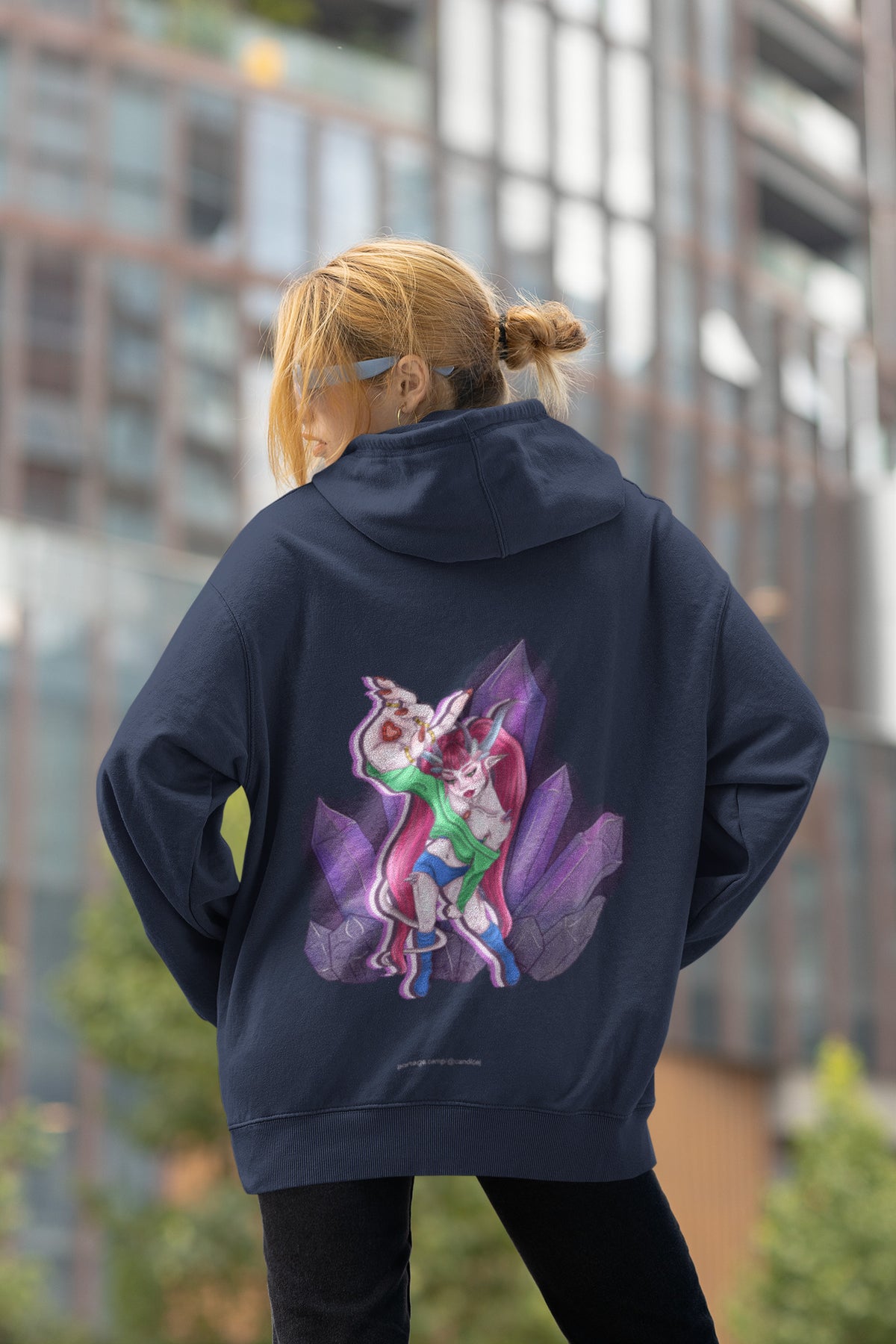 Heart Thief Zip Hoodie in Navy, worn by a woman seen from behind by tall city buildings, showing the large print on the back. Digital product mockup.