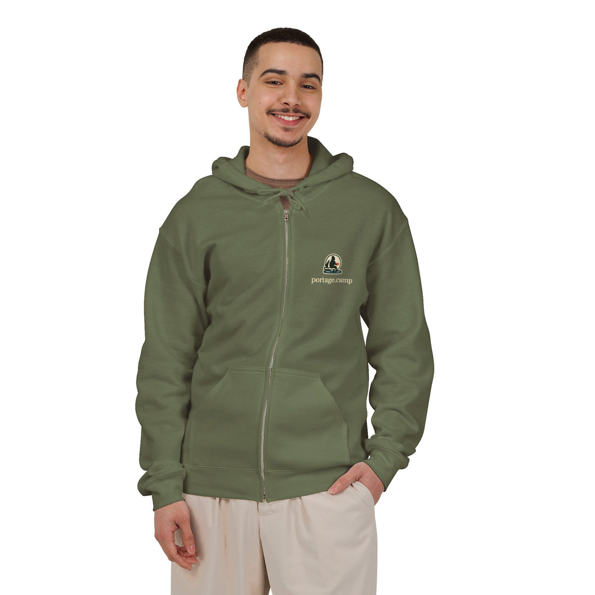 Quiet Hours Zip Hoodie in Military Green, worn by a man in a plain white studio, with the Quiet Hours logo and portage.camp on the left chest. Digital product mockup.