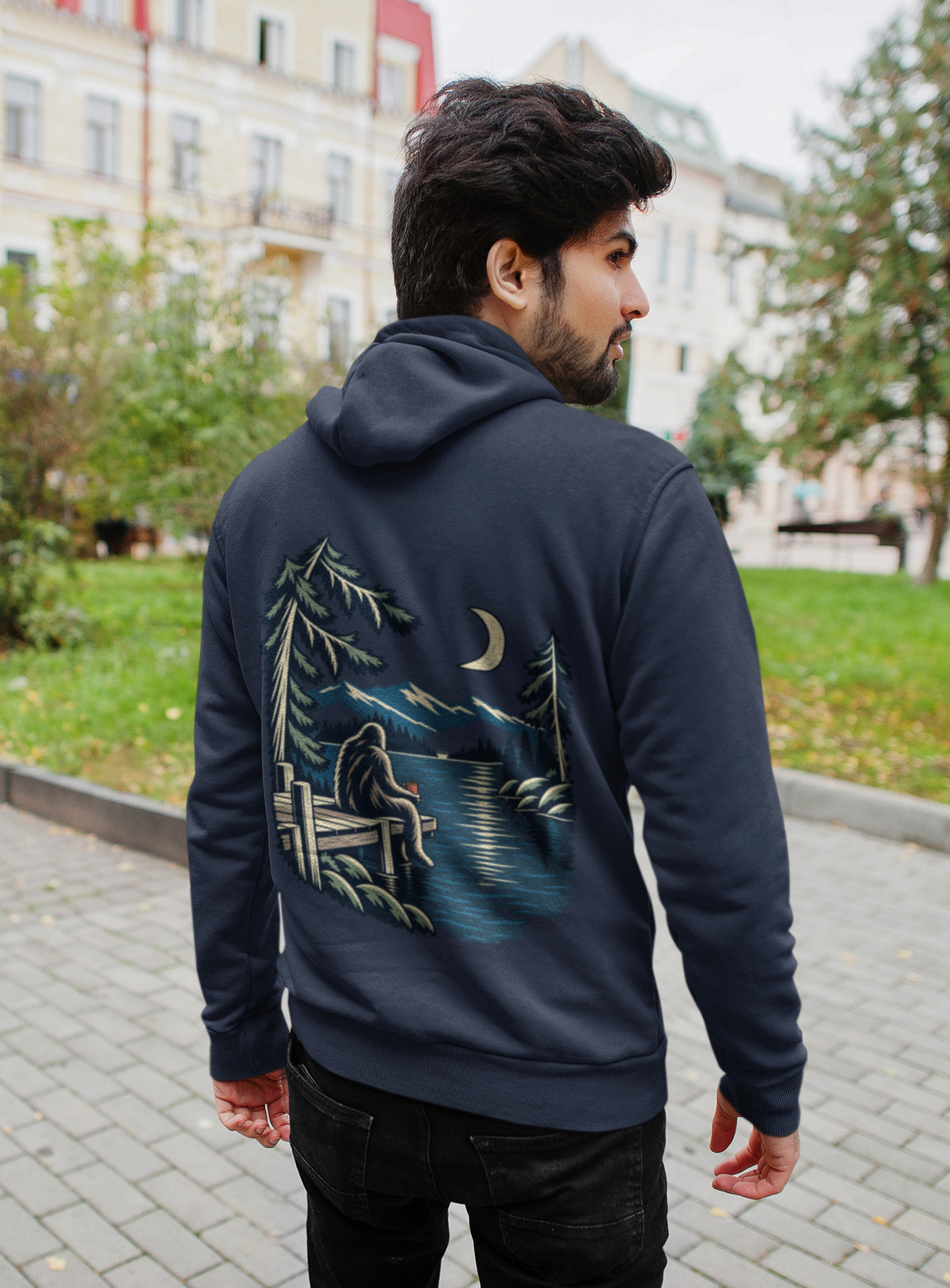 Quiet Hours Zip Hoodie in Navy, worn by a man seen from behind on a quiet city street, showing the large print on the back. Digital product mockup.