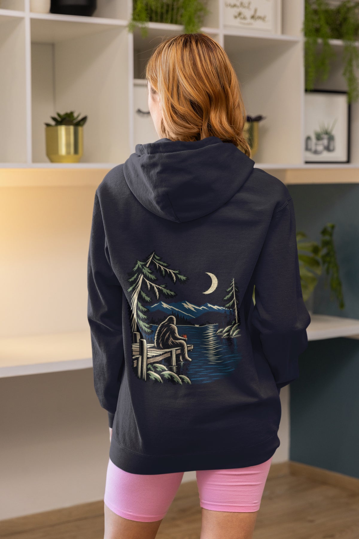 Quiet Hours Zip Hoodie in Navy, worn by a woman seen from behind at home, showing the large print on the back. Digital product mockup.