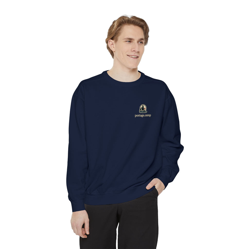 Quiet Hours Garment-Dyed Crewneck in True Navy, worn by a man in a plain white studio, with the Quiet Hours logo and portage.camp on the chest. Digital product mockup.