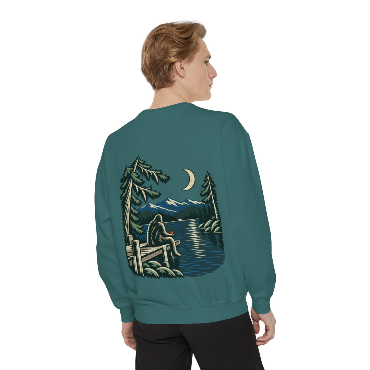 Quiet Hours Garment-Dyed Crewneck in Blue Spruce, worn by a man seen from behind in a plain white studio, showing the large print on the back. Digital product mockup.