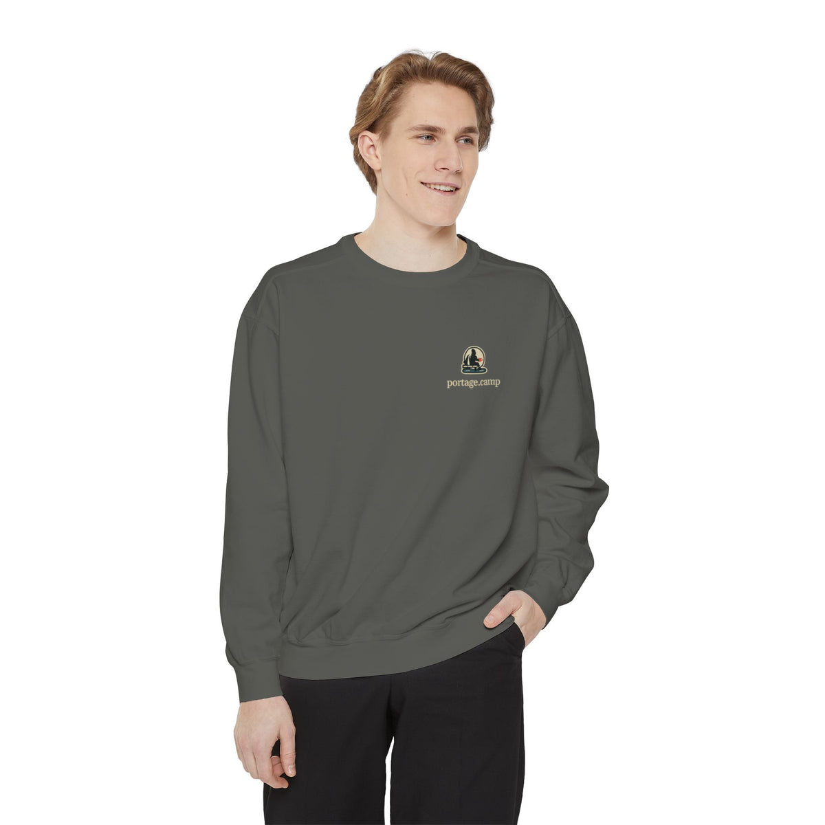 Quiet Hours Garment-Dyed Crewneck in Pepper, worn by a man in a plain white studio, with the Quiet Hours logo and portage.camp on the chest. Digital product mockup.